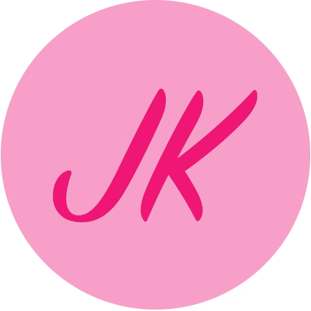 Pink circle with the dark pink letters JK in the center, written in a cursive font, on a light gray background.